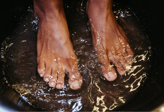 Close-up of male feet soaking in water for a relaxing spa treatment