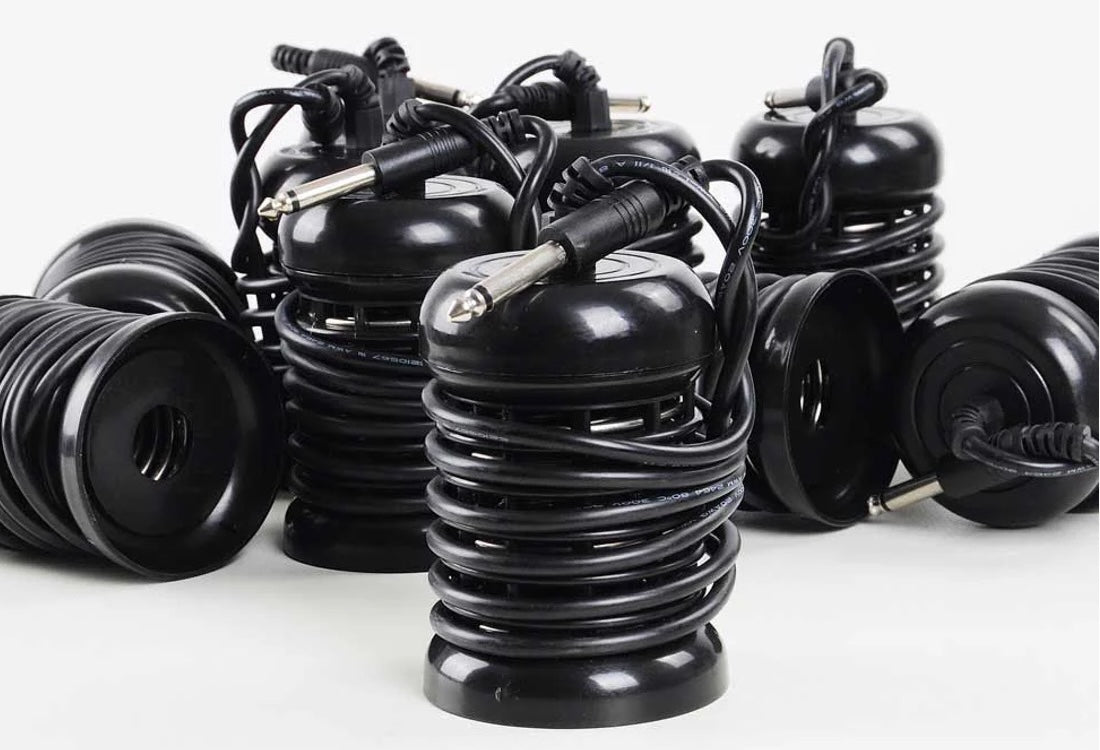 Several black coiled ionic foot detox arrays with jack connectors on a white background, illustrating the standard coil-type design