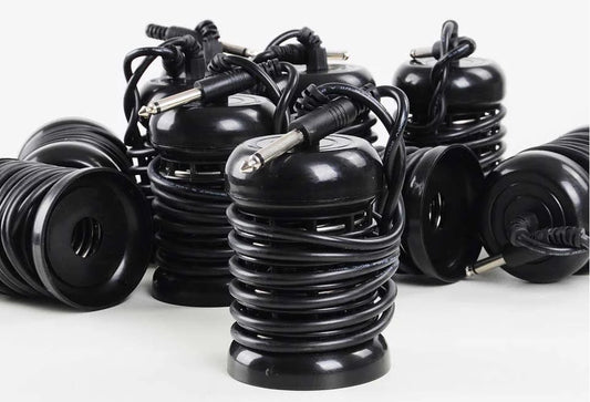 Several black coiled ionic foot detox arrays with jack connectors on a white background, illustrating the standard coil-type design